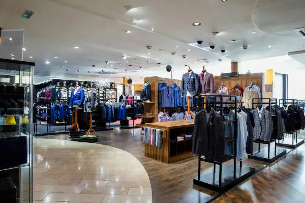 Modern clothing retail store interior with various garments on display