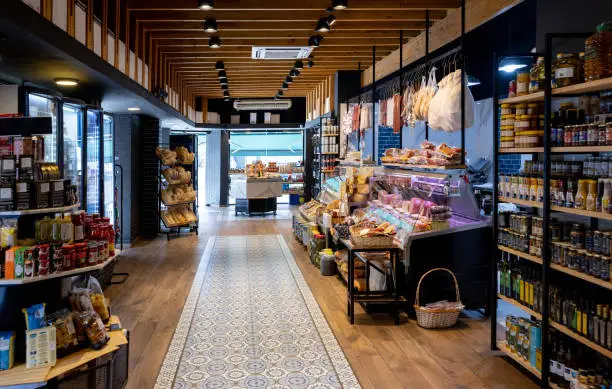 Interior view of a gourmet grocery store with shelves stocked with various food items